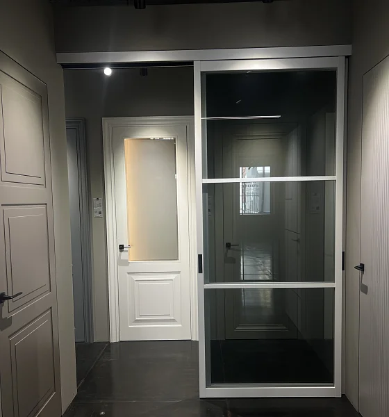 Раздвижная перегородка STRATUS-DOMINO, модель DM-03, безопасное прозрачное серое стекло, каркас полотна в белом цвете. Трек видимый.